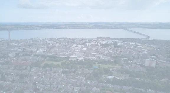 Aerial view capturing Dundee cityscape and Tay Bridge in Scotland